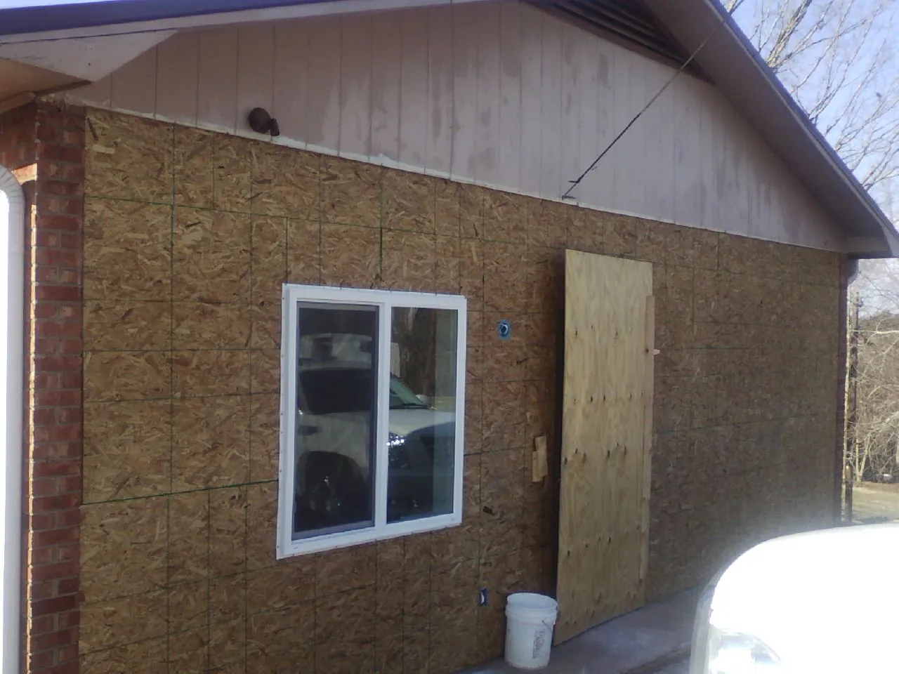 OSB sheathing on a garage addition wall before siding in Cocolalla